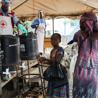 A_young_girl_washes_her_hands_in_an_Ebola_prevention_checkpoint_supported_by_UK_aid_at_a_Ugandan_border_crossing_point_with_the_DRC,_August_2019_(49423861413)